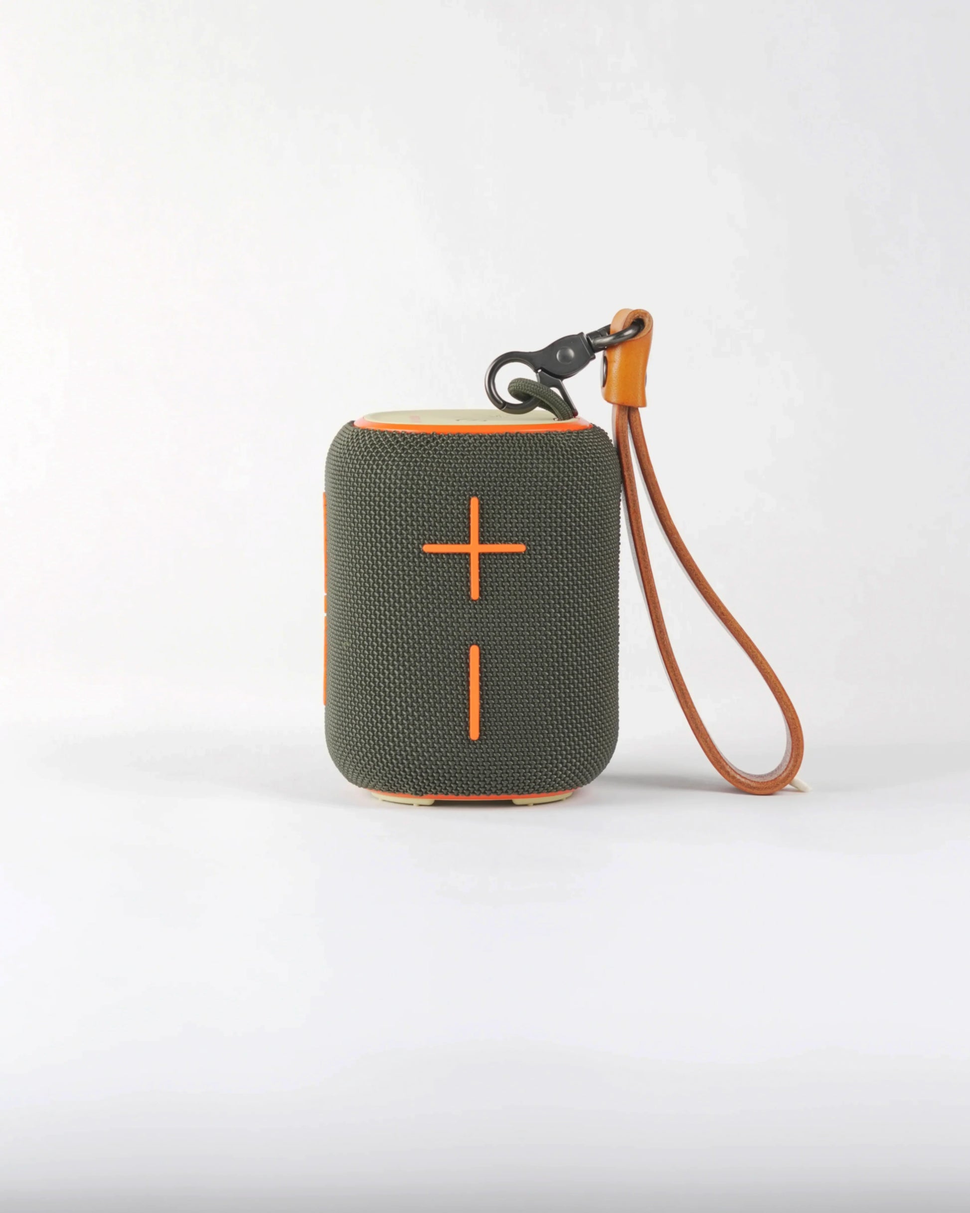 Close-up of the large orange cross-shaped volume buttons on the Belleville speaker, highlighting its bold urban aesthetic.