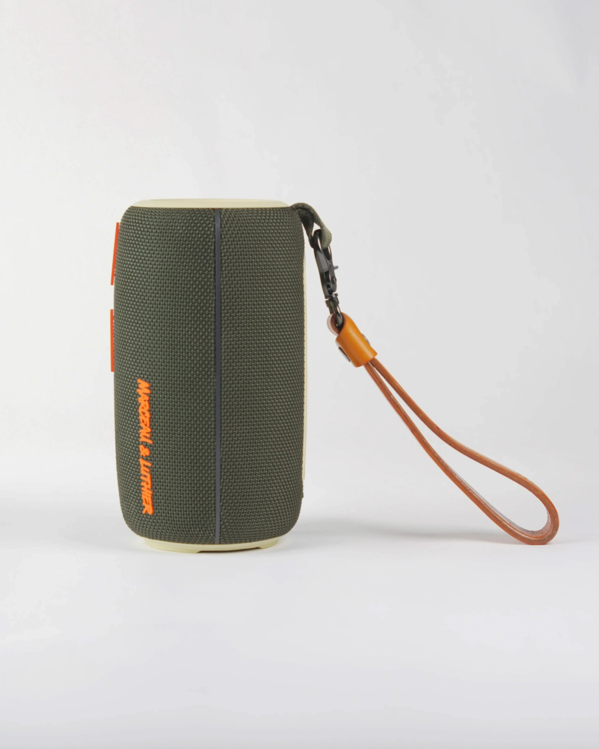 Side profile of the Pigalle wireless speaker highlighting its premium textured fabric and sleek urban design.