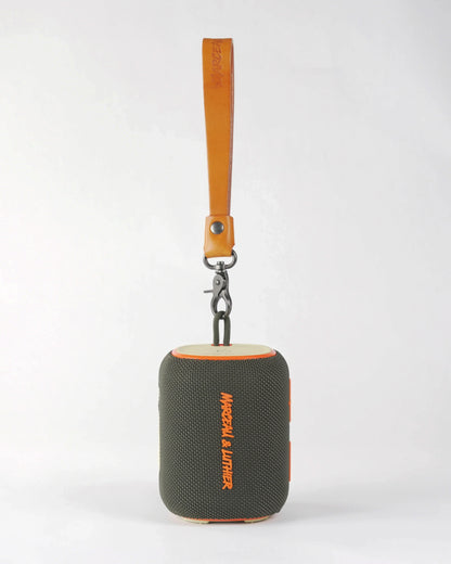 Front view of the Belleville portable speaker showing the high-quality tan leather handle and vibrant orange logo.