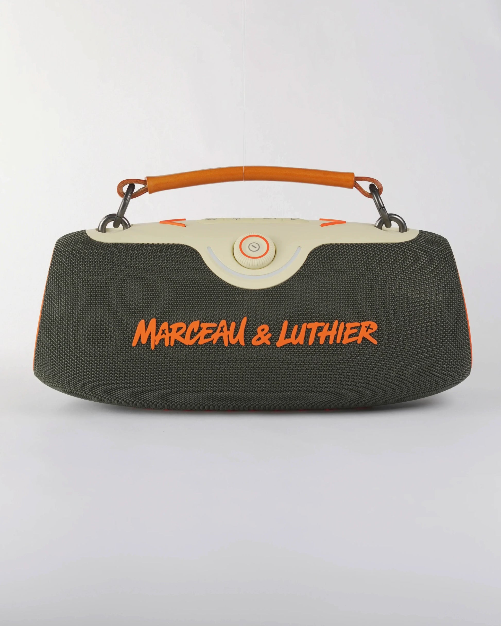 Front view of the Rive Droite speaker in dark green fabric with the signature orange Marceau & Luthier logo.